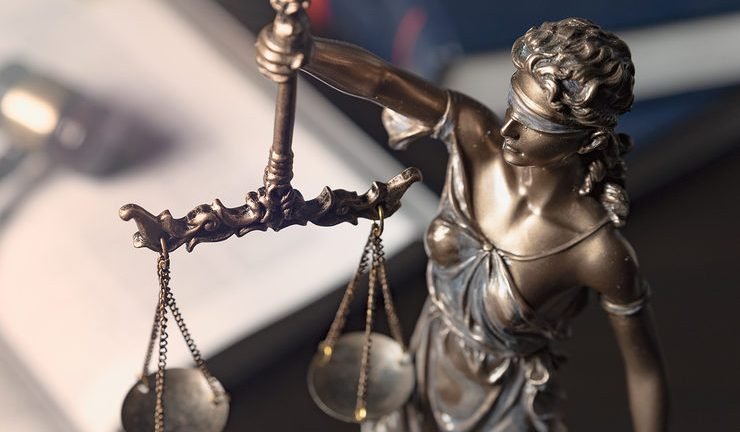 Statue Of Justice On Books Background